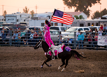 Small town rodeo arena with spectators in the stands
