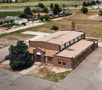 Historic brick schoolhouse in a small town setting