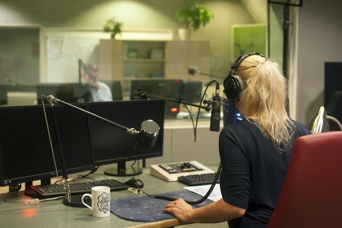 A community member being interviewed at a kitchen table