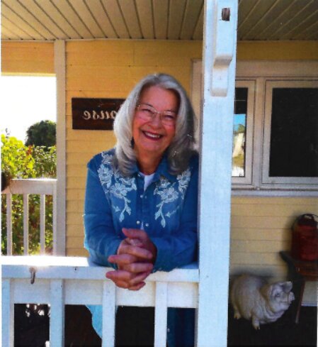 Smiling Keenesburg residents gathered on a front porch sharing stories